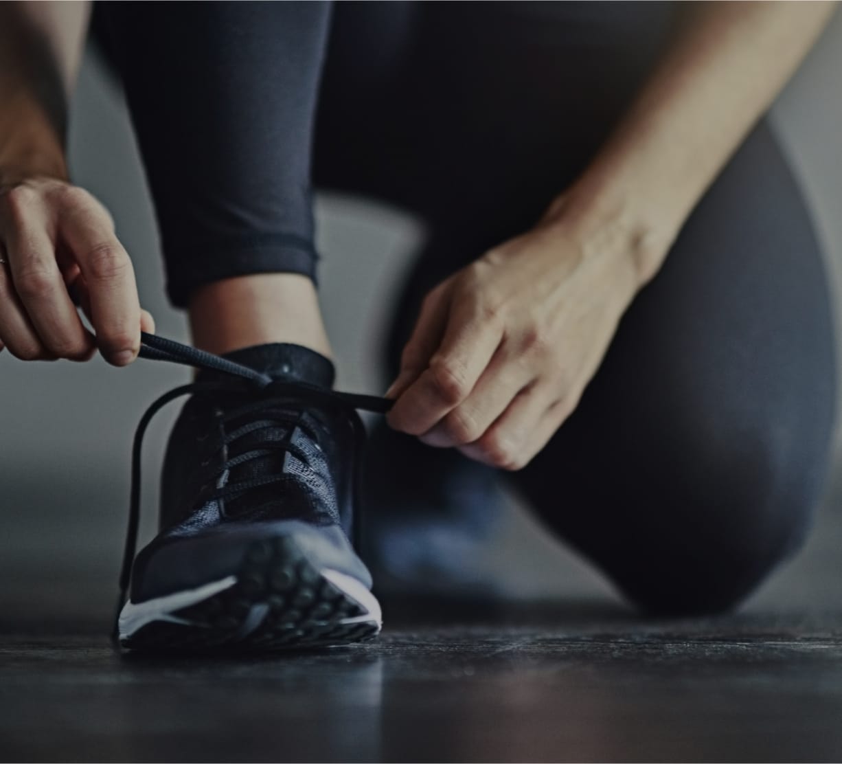 person tying their shoes