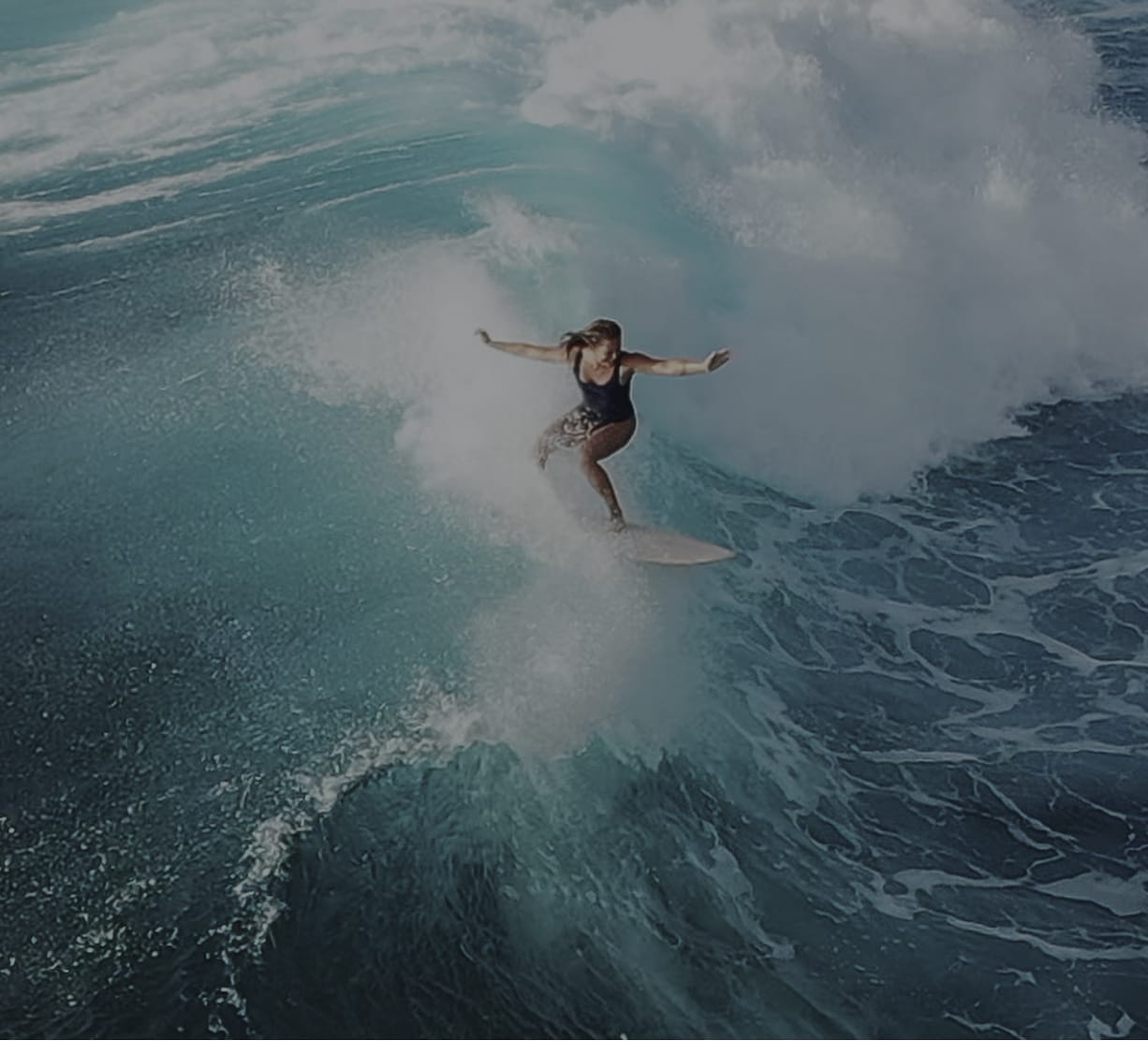 woman surfing on a wave